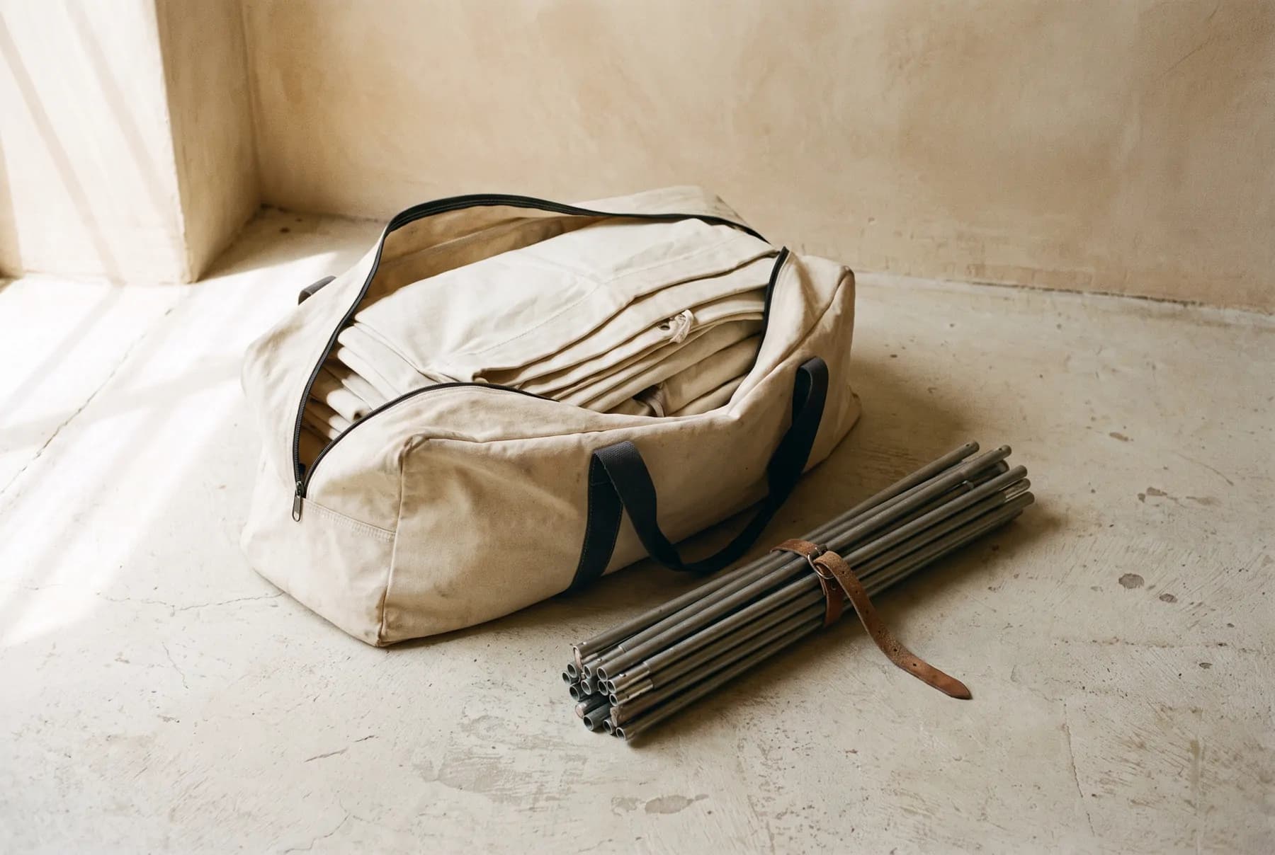 The carry bag opened, showing the folded canvas and bundled poles