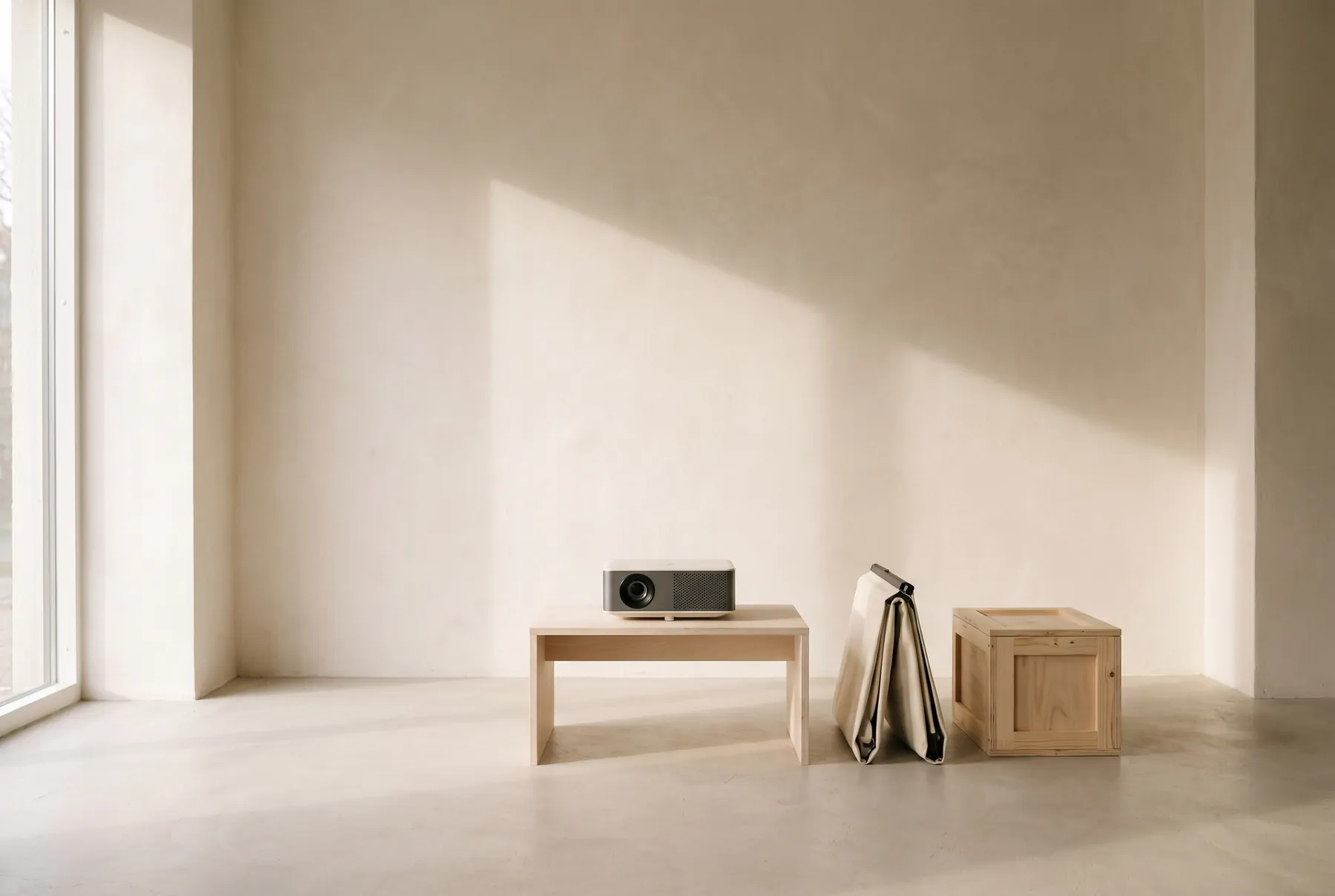 A projector on a low table beside a folded screen